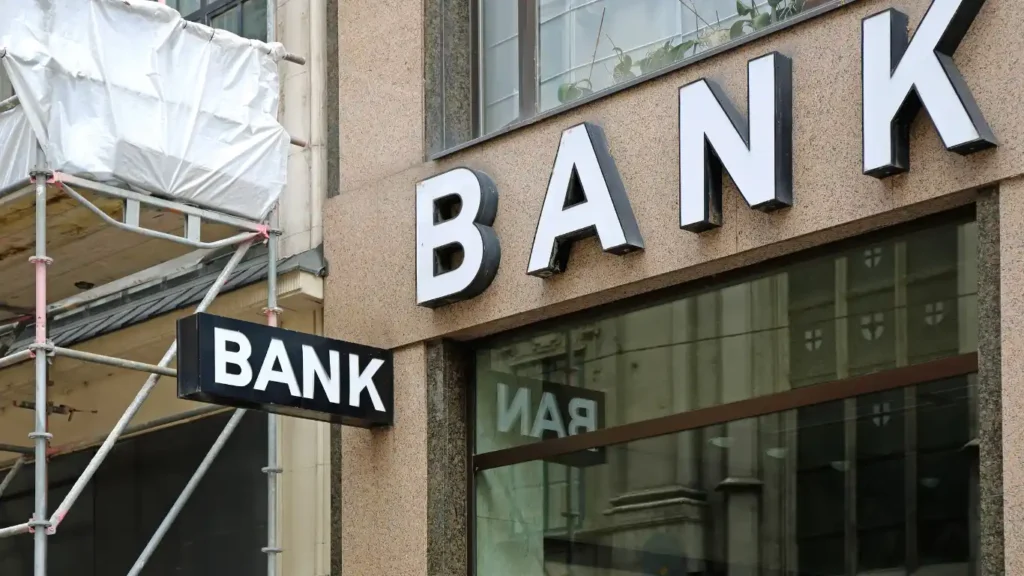 Exterior of a bank building in the United States with large “BANK” signage on the facade