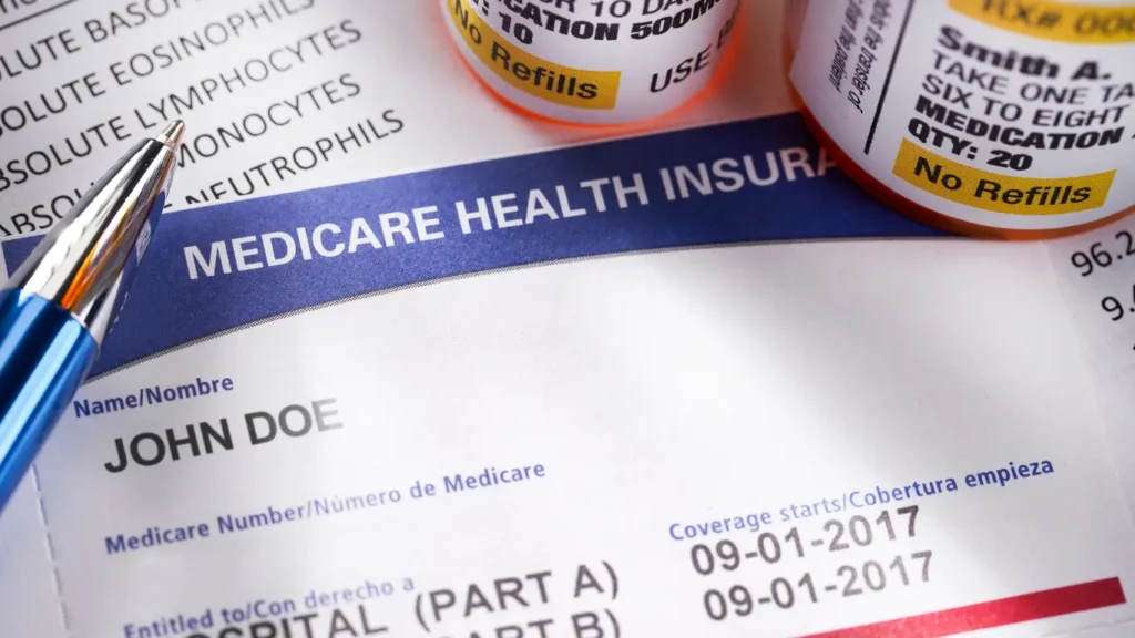 Close-up of a Medicare health insurance card with prescription medication bottles, illustrating Medicare coverage and healthcare planning.