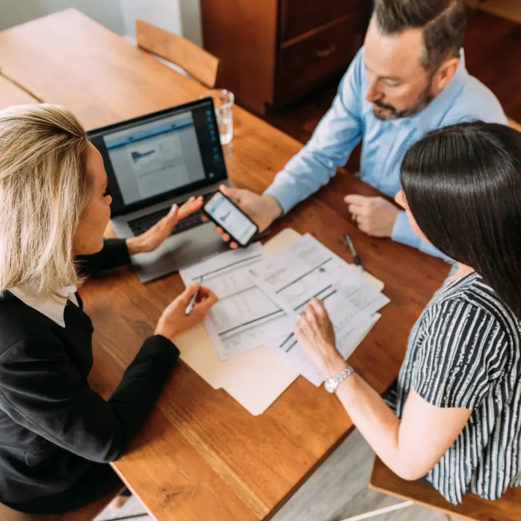 Kennedy Kha Phan – Financial Advisor – Personalized Financial Planning Financial advisor meeting with a couple to review financial documents, investment accounts, and long-term financial goals.